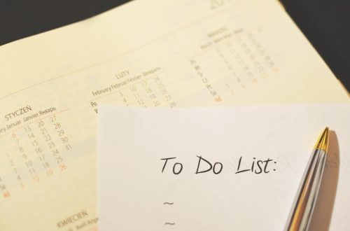 Close-up of a calendar and to-do list on a desk, emphasizing planning and organization.